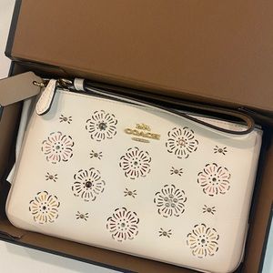 Cream coach wristlet with flower detail!